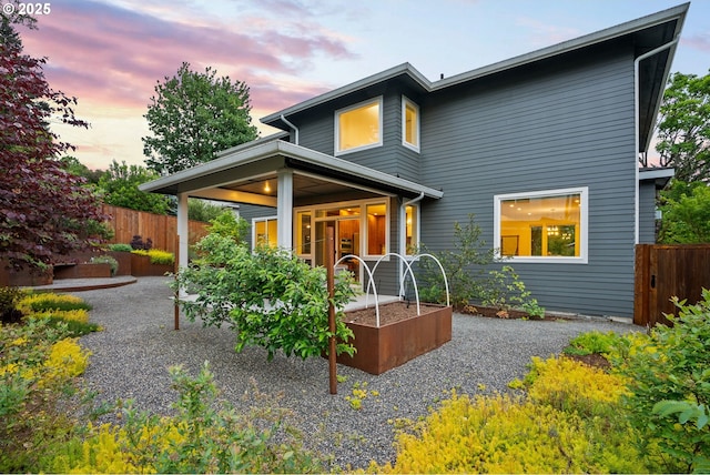 927 SW Maplecrest Ct, Portland, OR 97219 - rear view of property with a vegetable garden