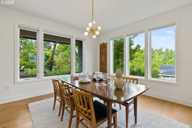 927 SW Maplecrest Ct, Portland, OR 97219 - dining space featuring baseboards, light wood-style flooring, and a chandelier