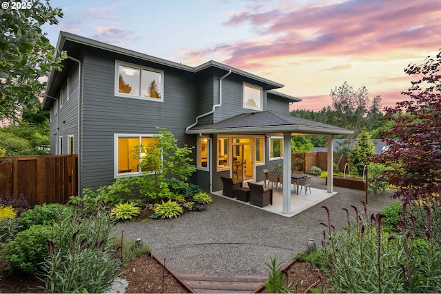927 SW Maplecrest Ct, Portland, OR 97219 - back of property at dusk featuring a patio