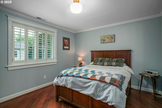 bedroom featuring baseboards, wood finished floors, and crown molding