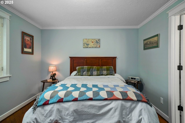 bedroom featuring wood finished floors, baseboards, and ornamental molding