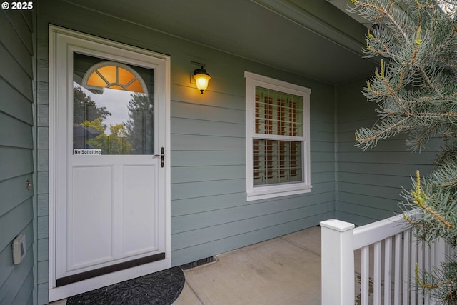 view of exterior entry with covered porch