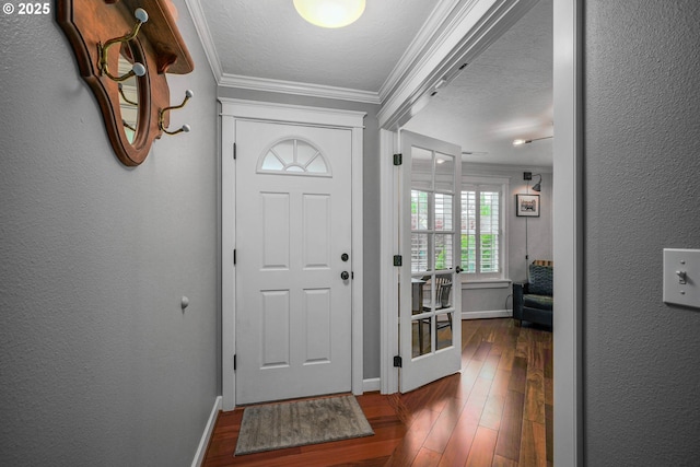 foyer entrance with crown molding, baseboards, and dark wood-style floors