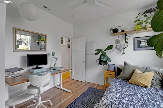 9115 N Richmond Ave, Portland, OR 97203 - bedroom featuring an office area, wood finished floors, multiple windows, and ceiling fan