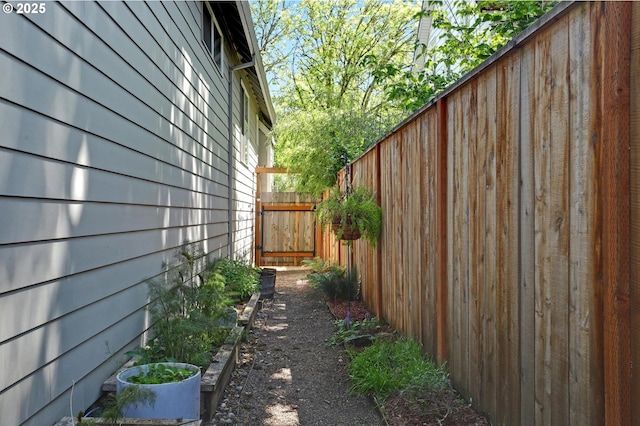 9115 N Richmond Ave, Portland, OR 97203 - view of home's exterior with fence and a vegetable garden
