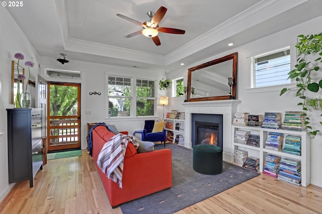 9115 N Richmond Ave, Portland, OR 97203 - living room with wood finished floors, a glass covered fireplace, ceiling fan, ornamental molding, and a tray ceiling