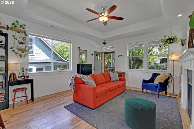 9115 N Richmond Ave, Portland, OR 97203 - living area featuring a tray ceiling, ornamental molding, hardwood / wood-style flooring, ceiling fan, and a fireplace
