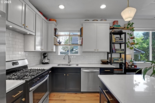 9115 N Richmond Ave, Portland, OR 97203 - kitchen featuring appliances with stainless steel finishes, a sink, plenty of natural light, light wood-style flooring, and recessed lighting