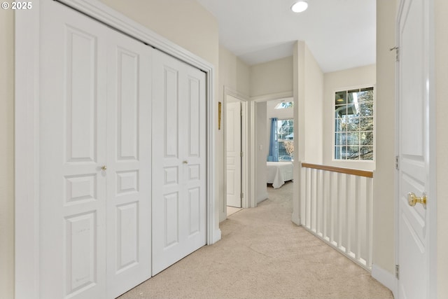 hallway featuring light carpet