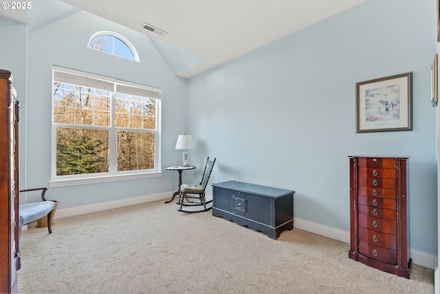 living area featuring vaulted ceiling and light carpet