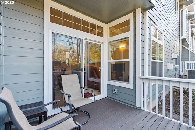 deck featuring cooling unit and covered porch