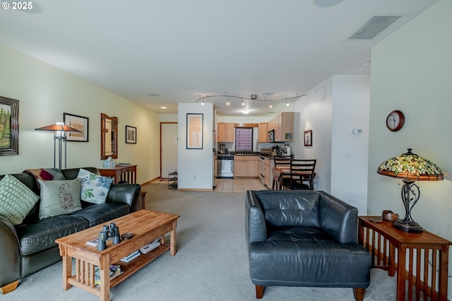606 NW Naito Pkwy Unit A14, Portland, OR 97209 - living area with light carpet, baseboards, visible vents, and rail lighting