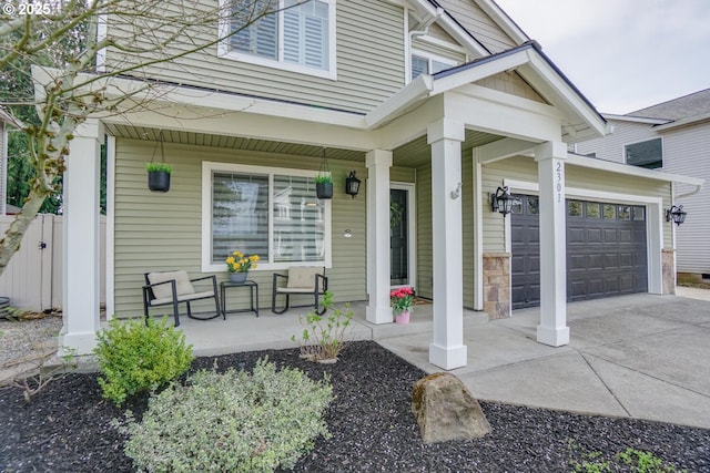 2301 NW 15th St, Battle Ground, WA 98604 - doorway to property featuring concrete driveway, an attached garage, and covered porch