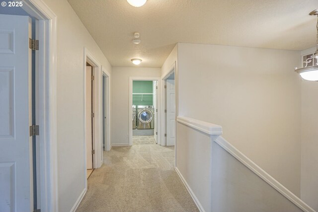 2301 NW 15th St, Battle Ground, WA 98604 - hall featuring baseboards, light carpet, an upstairs landing, a textured ceiling, and washer and dryer