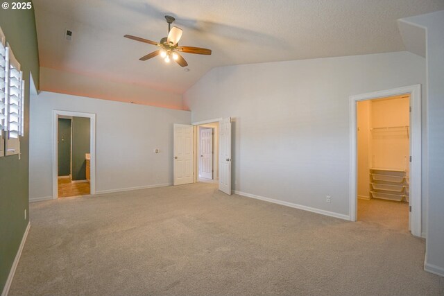 2301 NW 15th St, Battle Ground, WA 98604 - unfurnished bedroom with baseboards, a walk in closet, carpet, and lofted ceiling