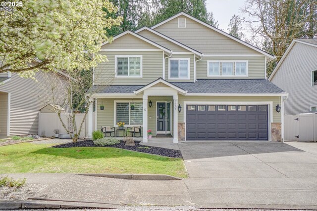 2301 NW 15th St, Battle Ground, WA 98604 - craftsman house with a porch, an attached garage, fence, concrete driveway, and roof with shingles