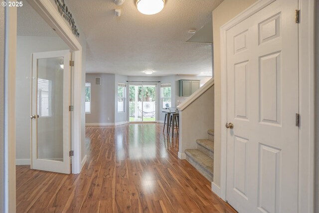2301 NW 15th St, Battle Ground, WA 98604 - corridor with a textured ceiling, wood finished floors, baseboards, and stairway