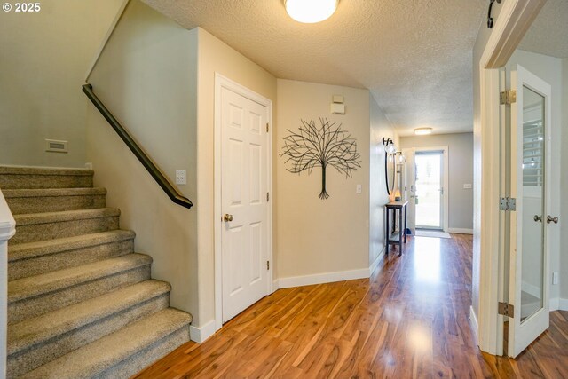 2301 NW 15th St, Battle Ground, WA 98604 - entrance foyer with a textured ceiling, wood finished floors, baseboards, and stairway