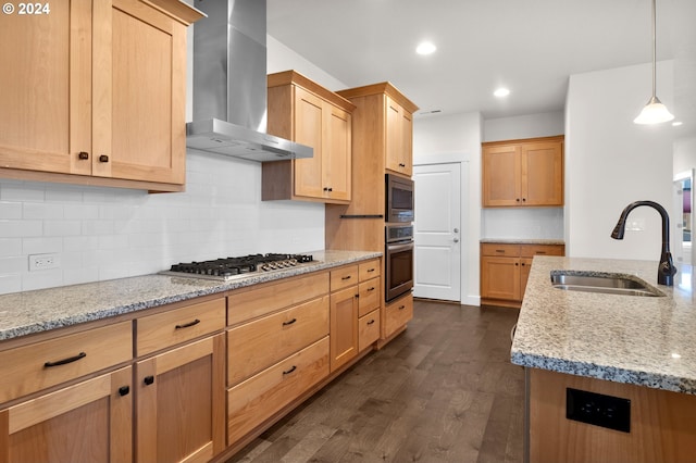 kitchen with appliances with stainless steel finishes, sink, light stone counters, and wall chimney exhaust hood