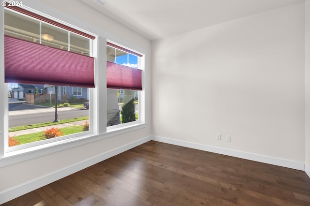 unfurnished room featuring dark hardwood / wood-style floors