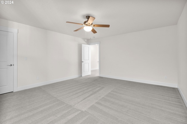 empty room featuring light colored carpet and ceiling fan