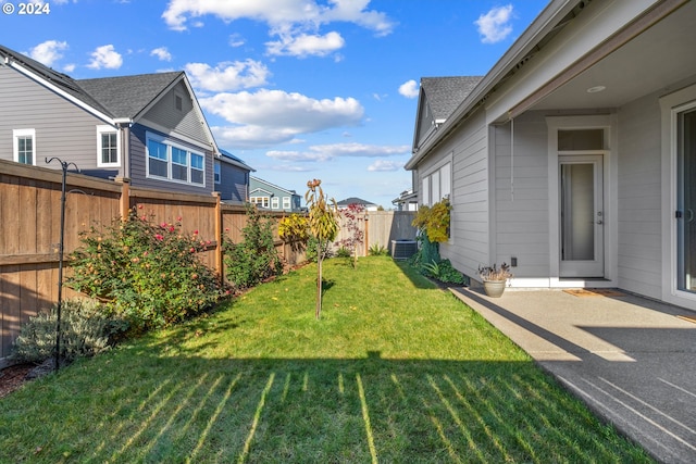 view of yard featuring central air condition unit and a patio