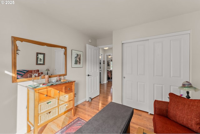 sitting room featuring baseboards and light wood finished floors