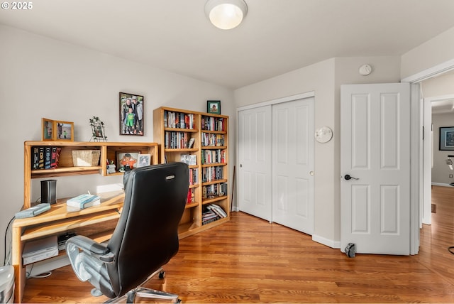 office area with wood finished floors and baseboards