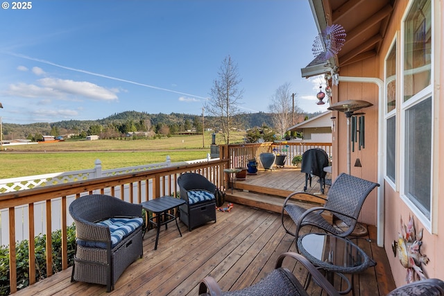 wooden terrace featuring a lawn