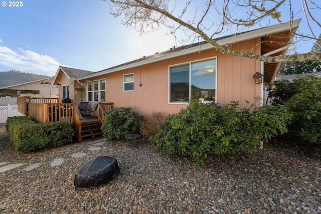 exterior space featuring fence and a deck