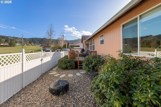 view of yard featuring fence and a deck