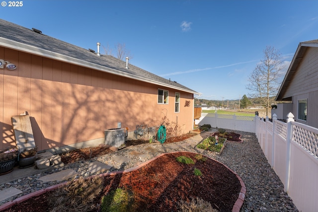 view of side of property featuring cooling unit and fence