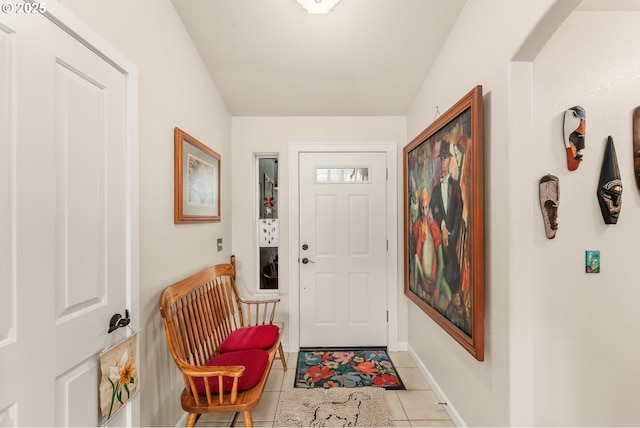 foyer entrance with tile patterned flooring and baseboards