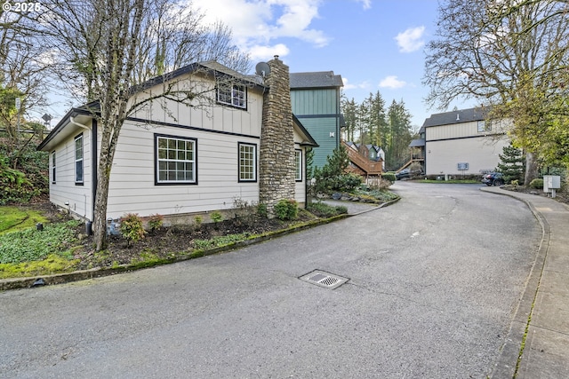 802 NW 5th Cir, Camas, WA 98607 - view of side of property with board and batten siding and a chimney