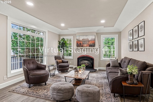 802 NW 5th Cir, Camas, WA 98607 - living room with a brick fireplace, recessed lighting, wood finished floors, and baseboards