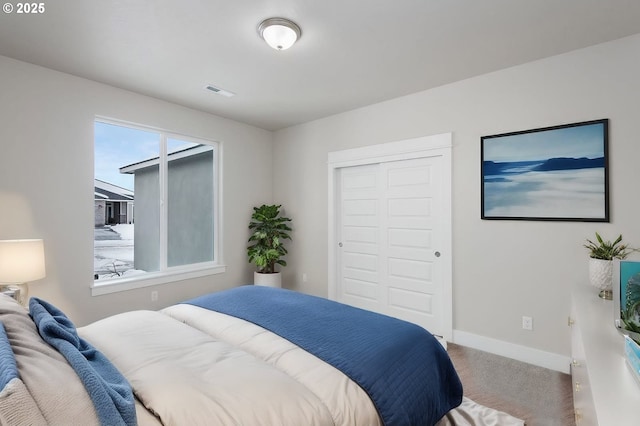 carpeted bedroom with a closet