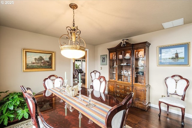 dining area with dark wood-style flooring, visible vents, and baseboards