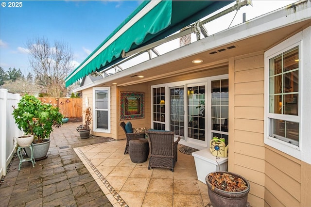 view of patio / terrace featuring fence