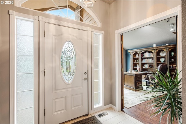 foyer entrance featuring light tile patterned flooring