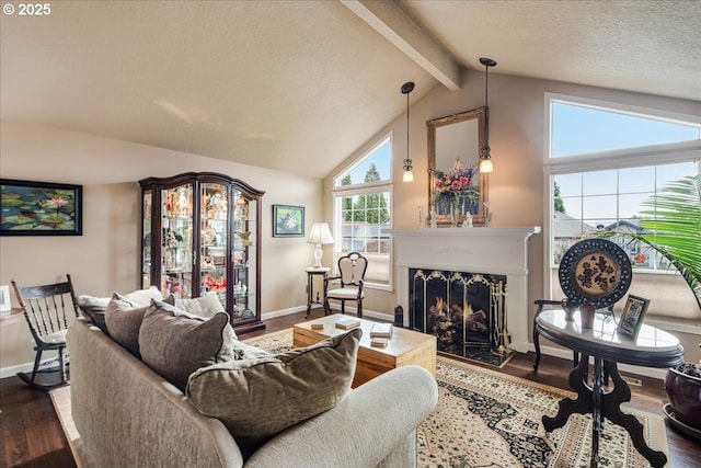 living room featuring vaulted ceiling with beams, a textured ceiling, wood finished floors, a high end fireplace, and baseboards