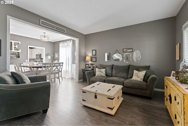 8775 SW Comanche Way, Tualatin, OR 97062 - living room with dark wood-style flooring and plenty of natural light