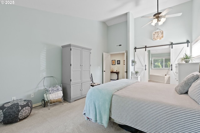 8775 SW Comanche Way, Tualatin, OR 97062 - bedroom featuring carpet flooring, high vaulted ceiling, and a barn door