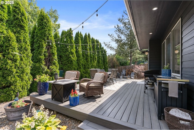 8775 SW Comanche Way, Tualatin, OR 97062 - wooden terrace with outdoor dining area and a fire pit