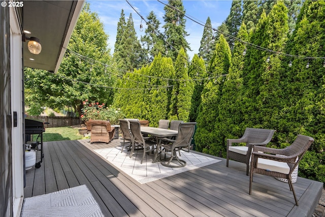 8775 SW Comanche Way, Tualatin, OR 97062 - wooden terrace with outdoor dining area and a grill