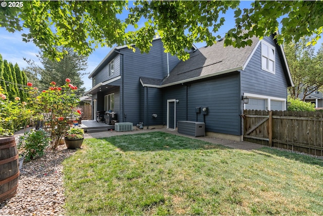 8775 SW Comanche Way, Tualatin, OR 97062 - rear view of property featuring a garage, a deck, and roof with shingles