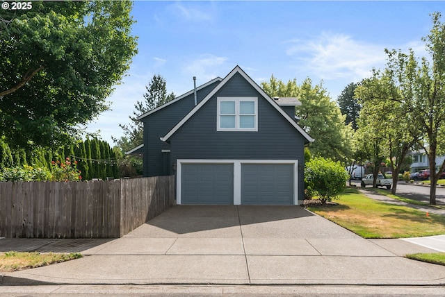 8775 SW Comanche Way, Tualatin, OR 97062 - view of side of home with concrete driveway and an attached garage