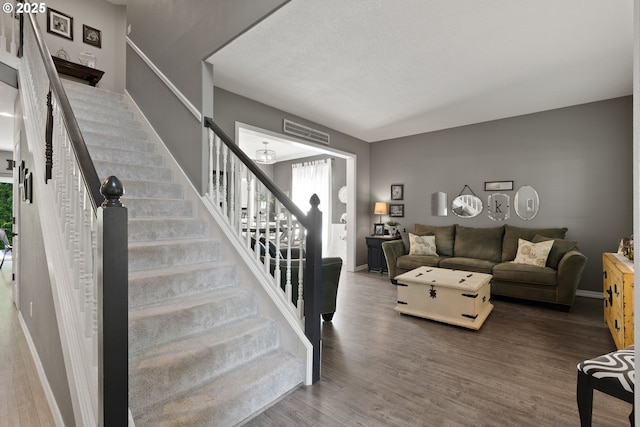 8775 SW Comanche Way, Tualatin, OR 97062 - living room featuring stairs and wood finished floors