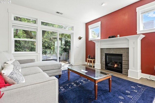 18 NE Cook St, Portland, OR 97212 - living room with a tiled fireplace and wood finished floors