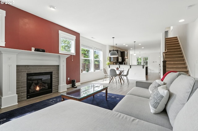 18 NE Cook St, Portland, OR 97212 - living area featuring wood finished floors, recessed lighting, stairs, and a tiled fireplace