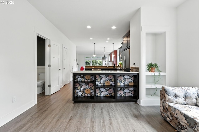 18 NE Cook St, Portland, OR 97212 - bar area with wood finished floors, recessed lighting, pendant lighting, and freestanding refrigerator